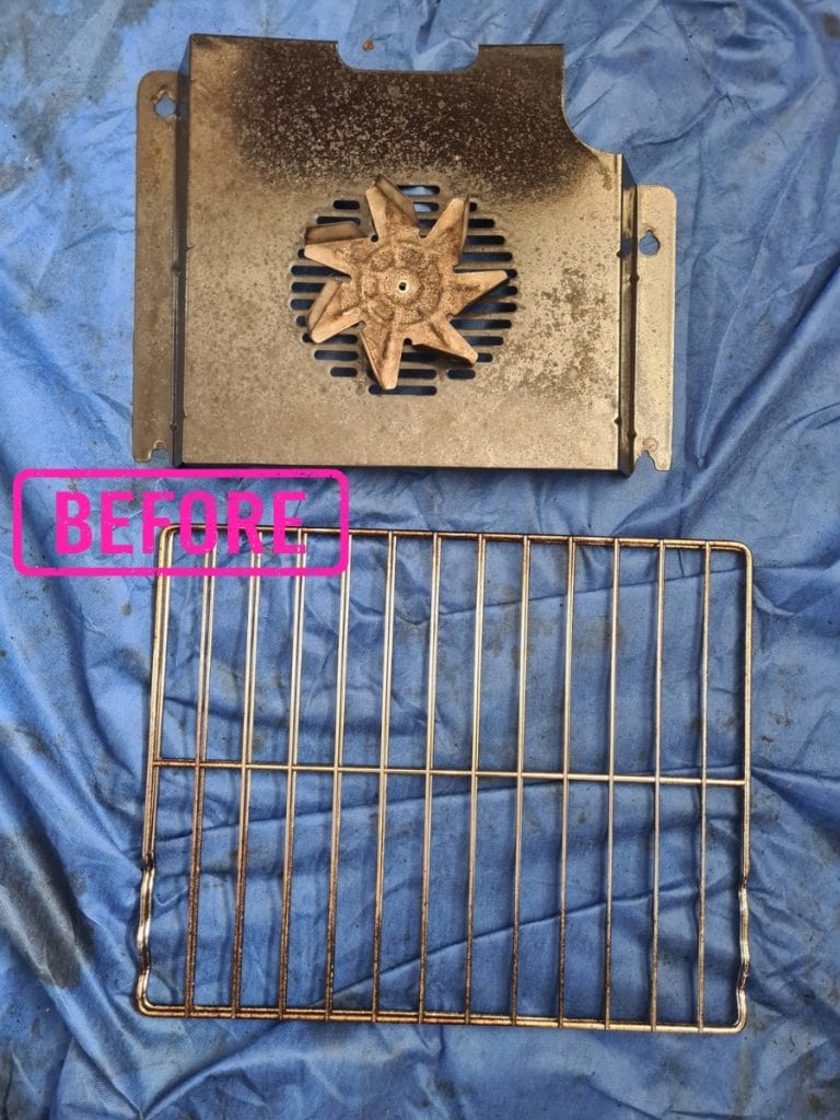 Before oven cleaning in Redditch showing the fan blade, back plate and shelf with built-up residue